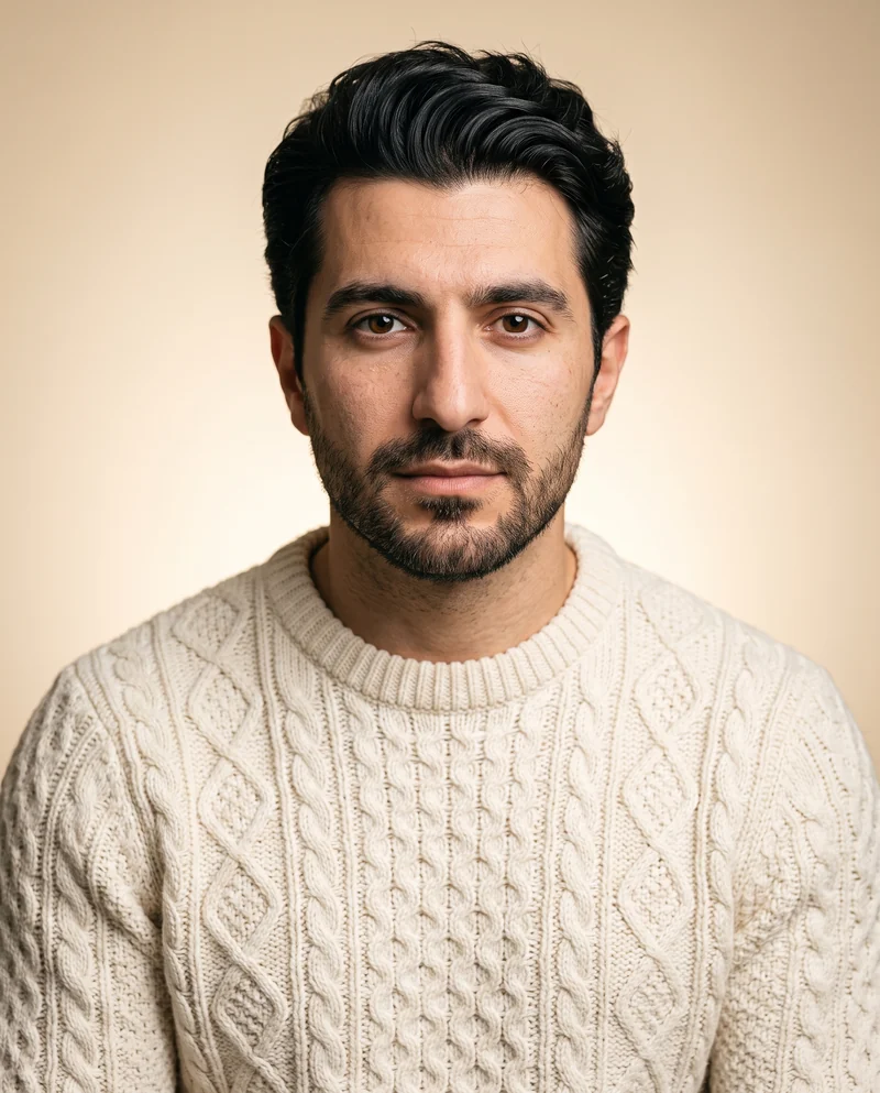 Portrait of Narek, a man in a cream cable knit sweater